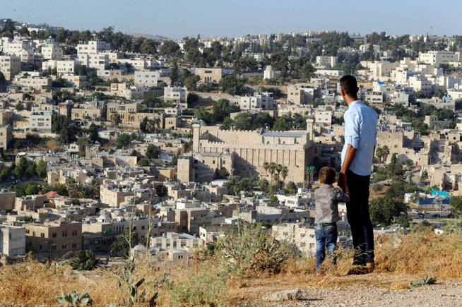 a general view as palestinians look at the west bank city of hebron july 7 2017 reuters ammar awad