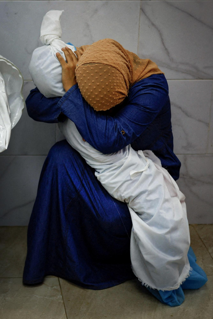 a palestinian woman embraces the body of her niece.r d.641 541